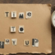 Ransom note style text reading 'Time to pay up' next to a stopwatch, representing the VMware Broadcom cost crisis.