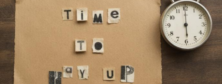 Ransom note style text reading 'Time to pay up' next to a stopwatch, representing the VMware Broadcom cost crisis.